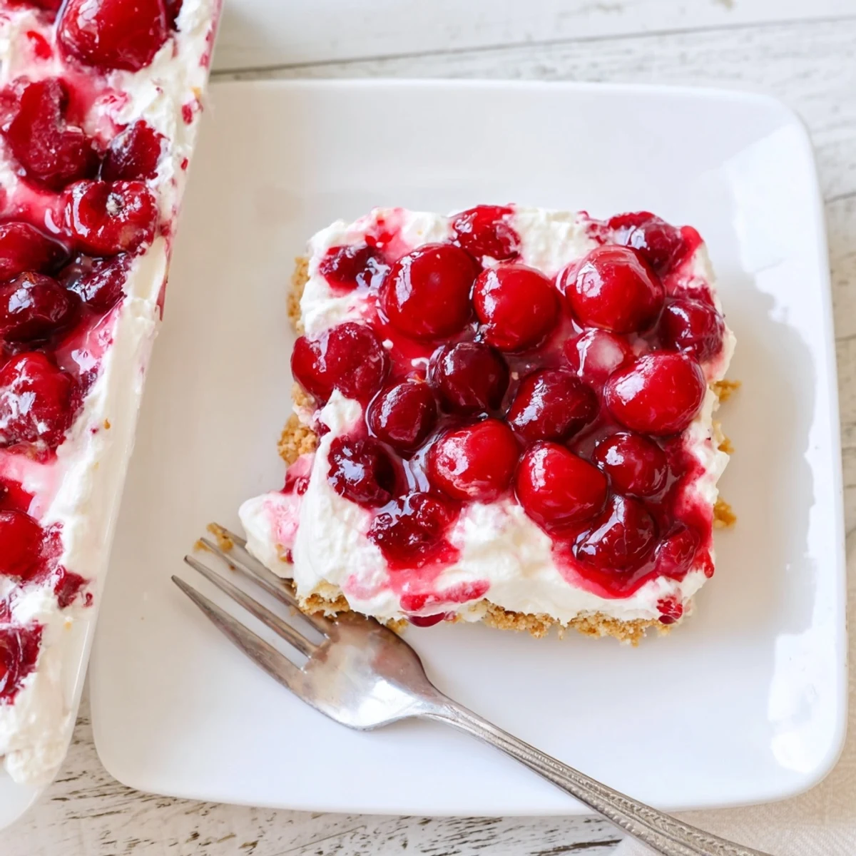 Classic Cherry Delight in a 9x13 dish, ready to chill, with ruby red cherries and smooth cream cheese filling.