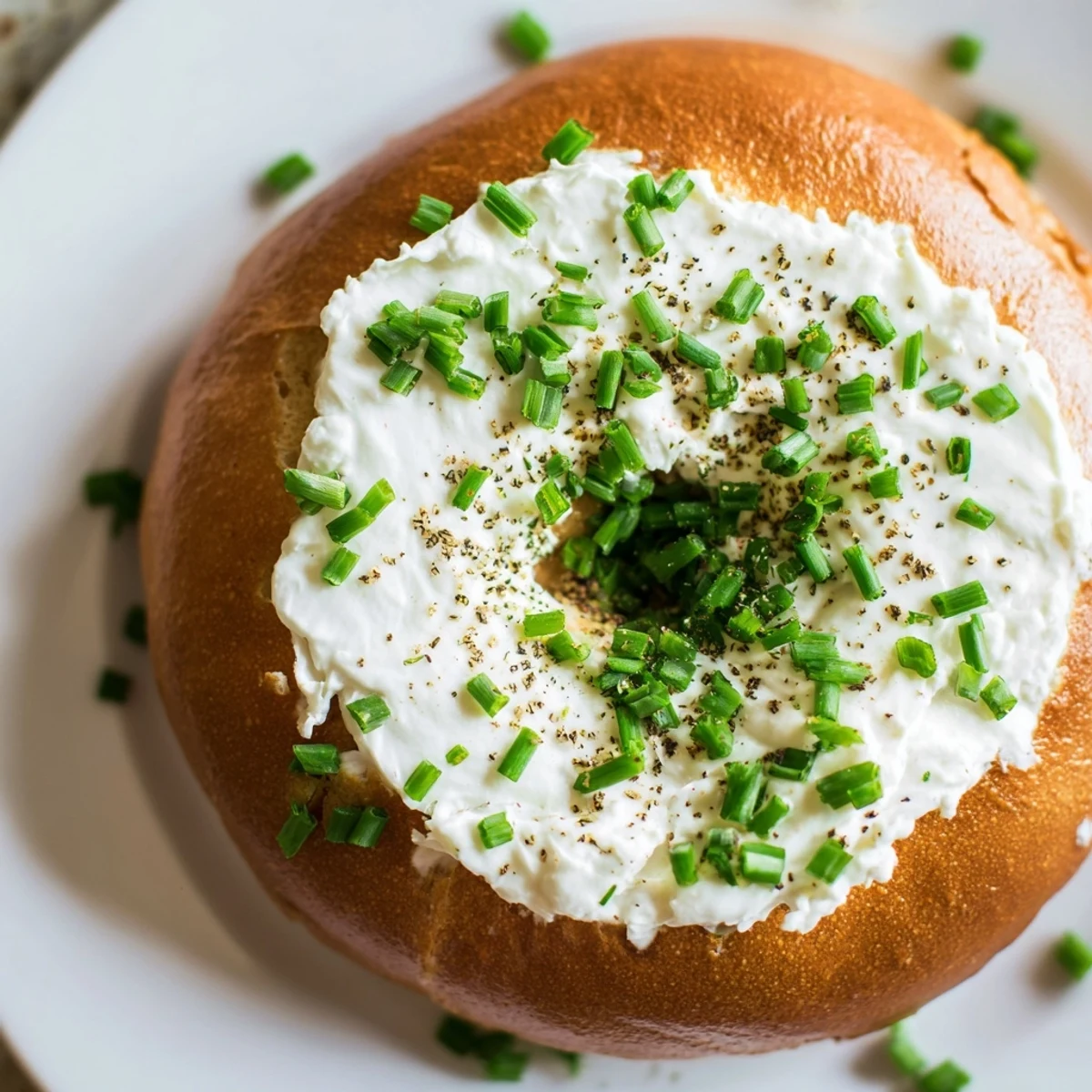 Sliced Protein Bagels with Cottage Cheese revealing a soft, chewy interior served beside black pepper.