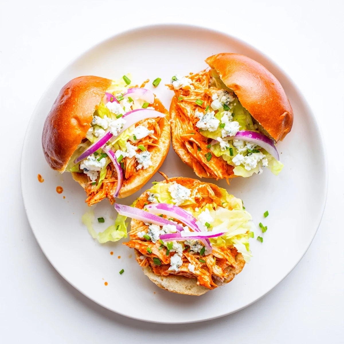 Golden toasted slider buns hold tender spicy Buffalo chicken, creamy blue cheese, and crisp lettuce for a game day treat.  
