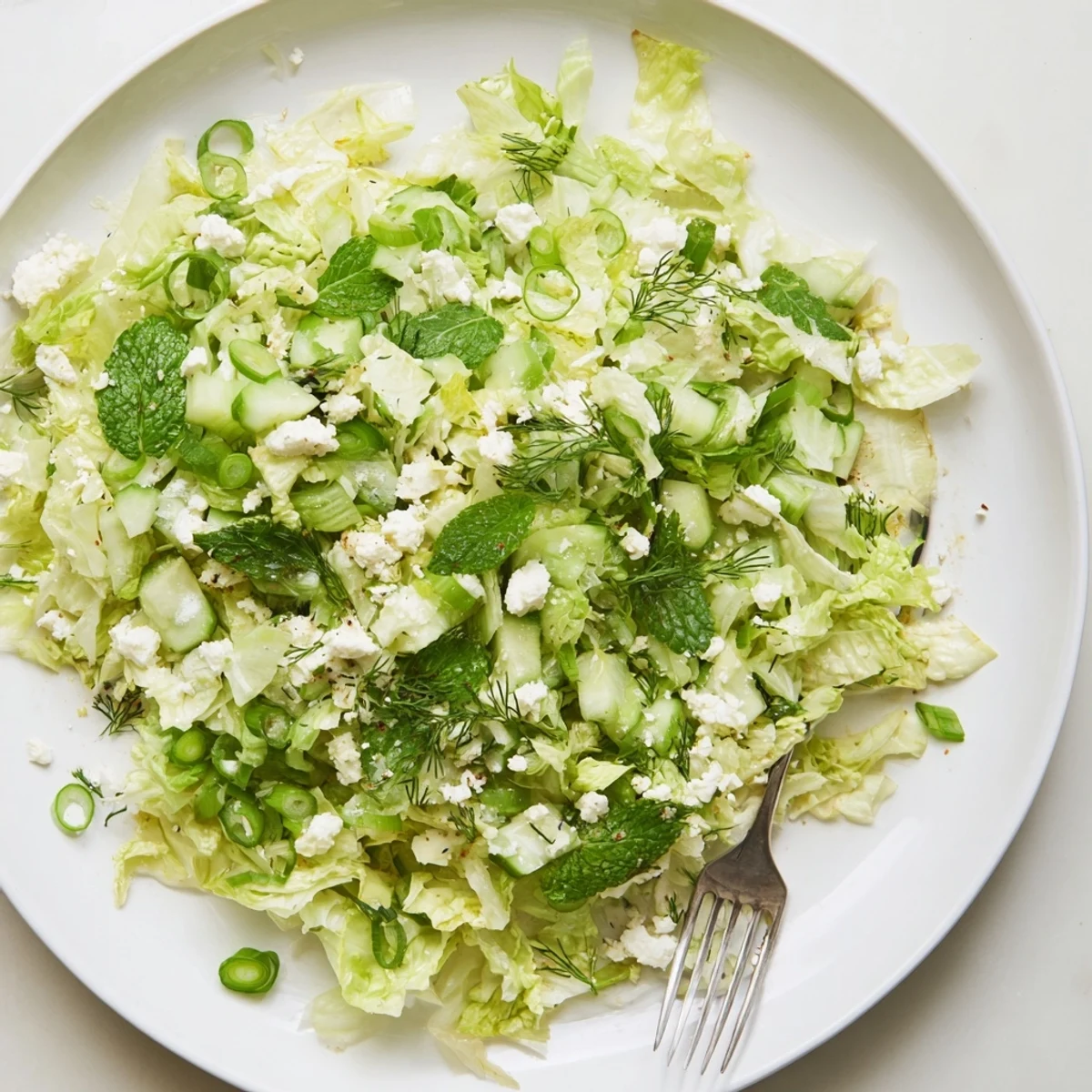 Fresh Maroulosalata Greek salad with shredded romaine, fragrant herbs, and bright lemon dressing