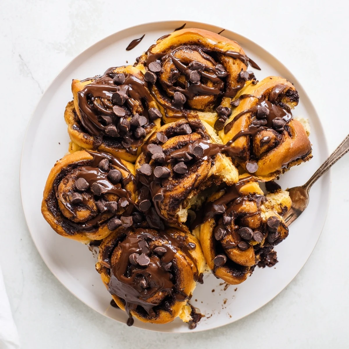 Warm double chocolate cinnamon rolls with gooey chocolate cinnamon filling and glossy chocolate topping