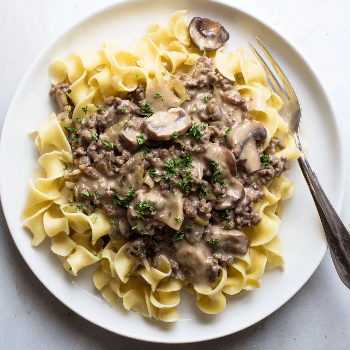 Rich hamburger stroganoff featuring ground beef in a savory sour cream sauce over noodles