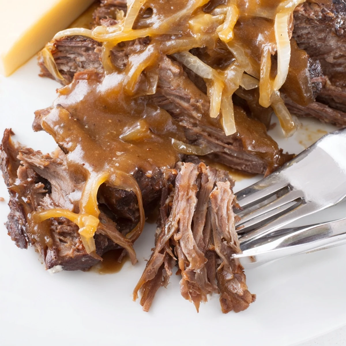 Savory chuck roast braised for hours with sweet onions and melted Gruyère cheese topping