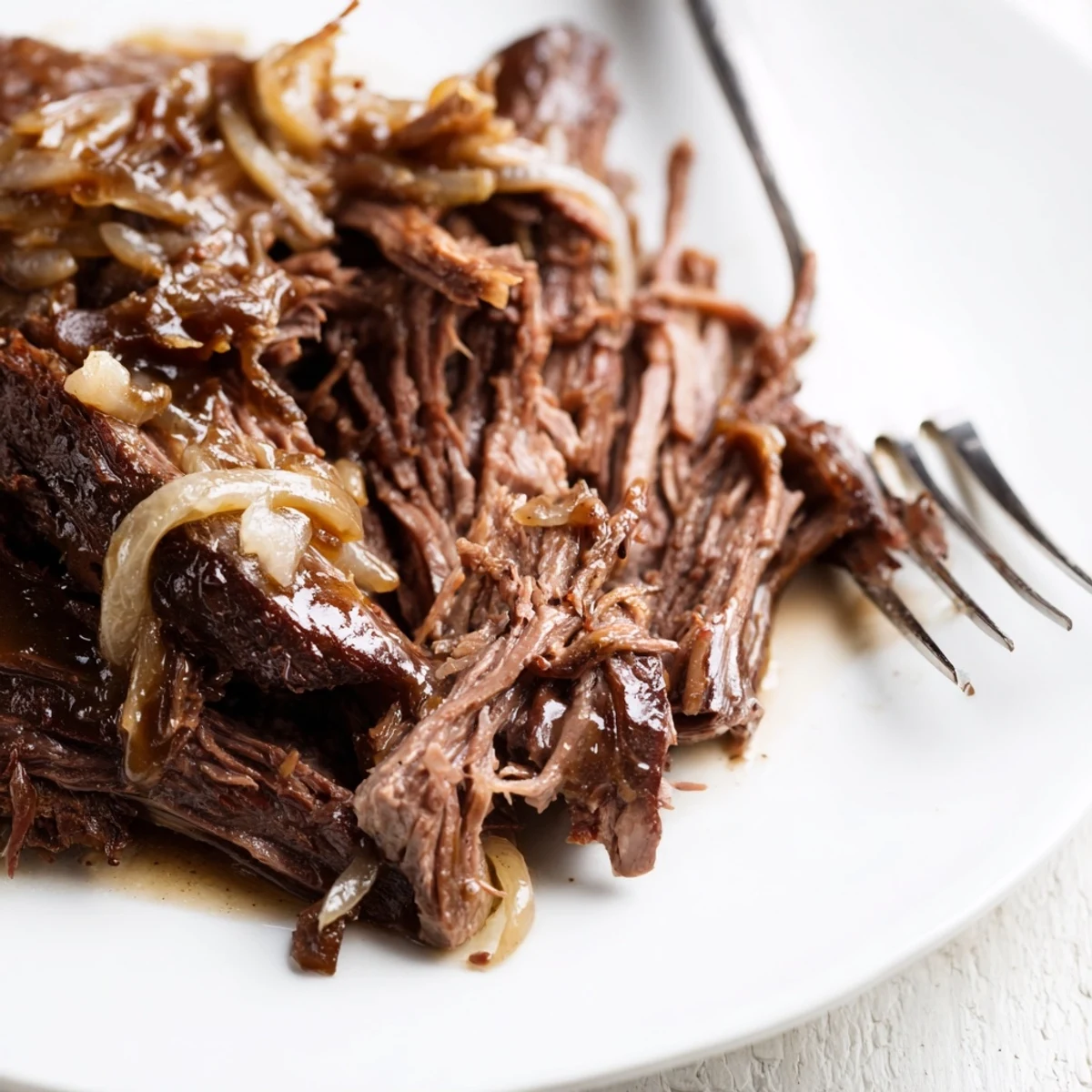 Fork-tender beef pot roast served with buttery vegetables and deep flavorful onion sauce