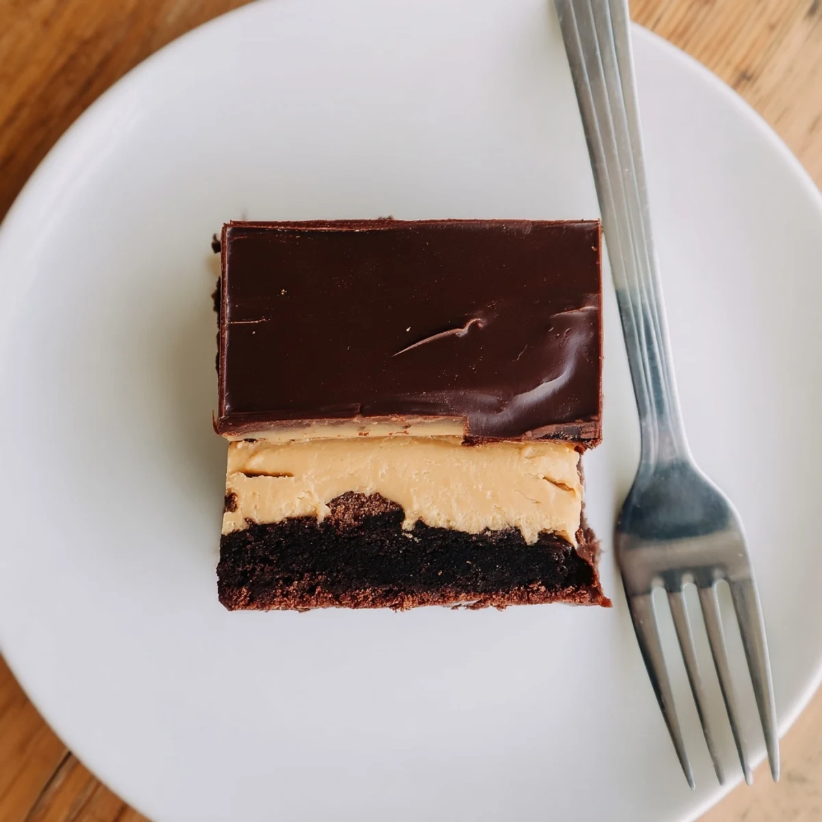 Decadent layered peanut butter brownies with smooth chocolate ganache and creamy peanut butter topping