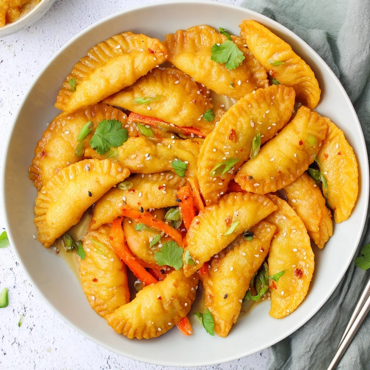 Crispy pan-fried potstickers tossed with fresh snap peas peppers and aromatic Asian sauce