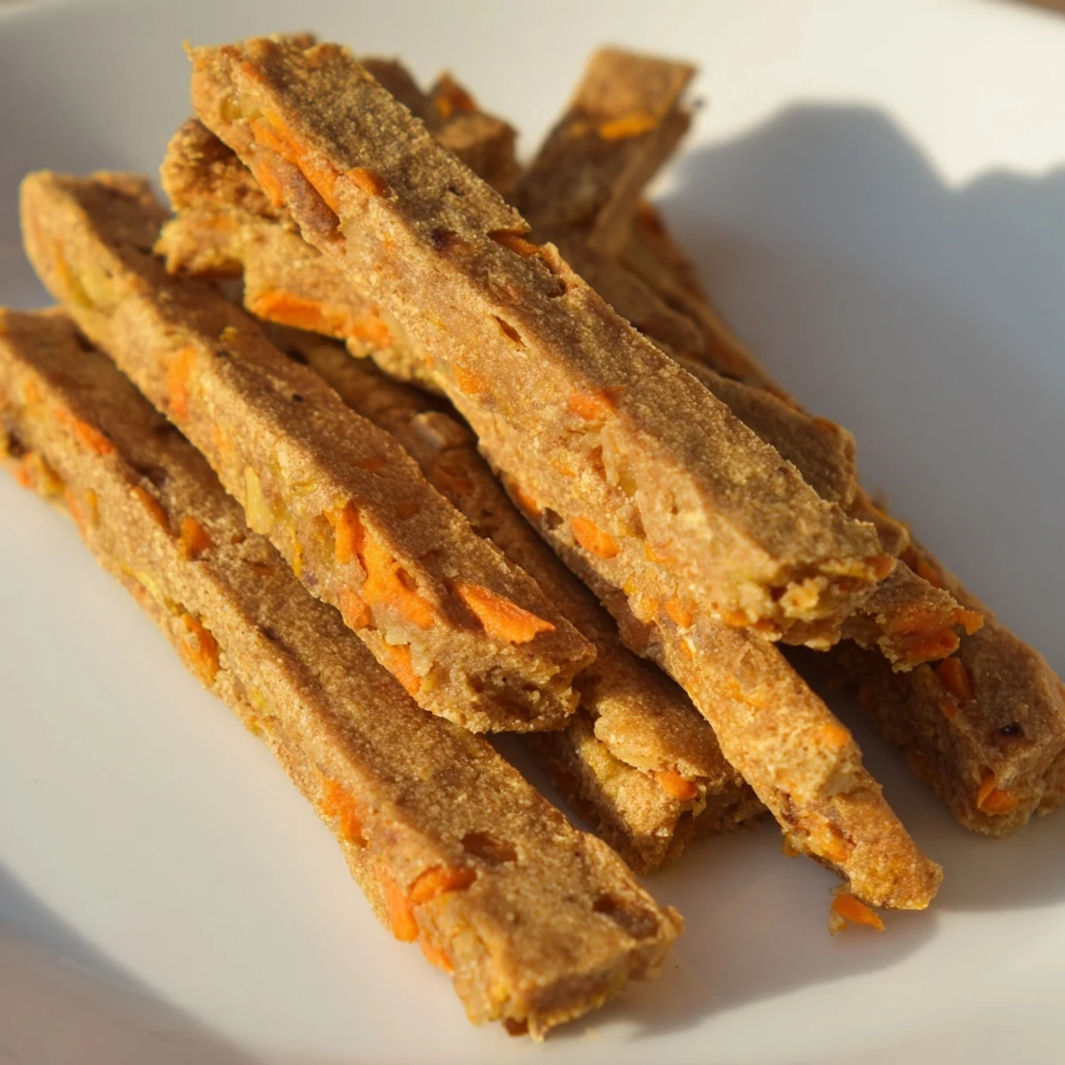 Oven-baked apple and carrot dog chew sticks with a satisfying crunch perfect for rewarding your happy pup
