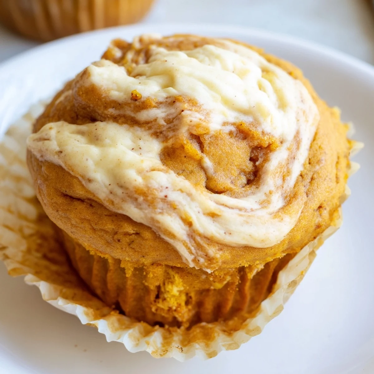 Warm chai pumpkin cheesecake muffins fresh from the oven with crackly domed tops