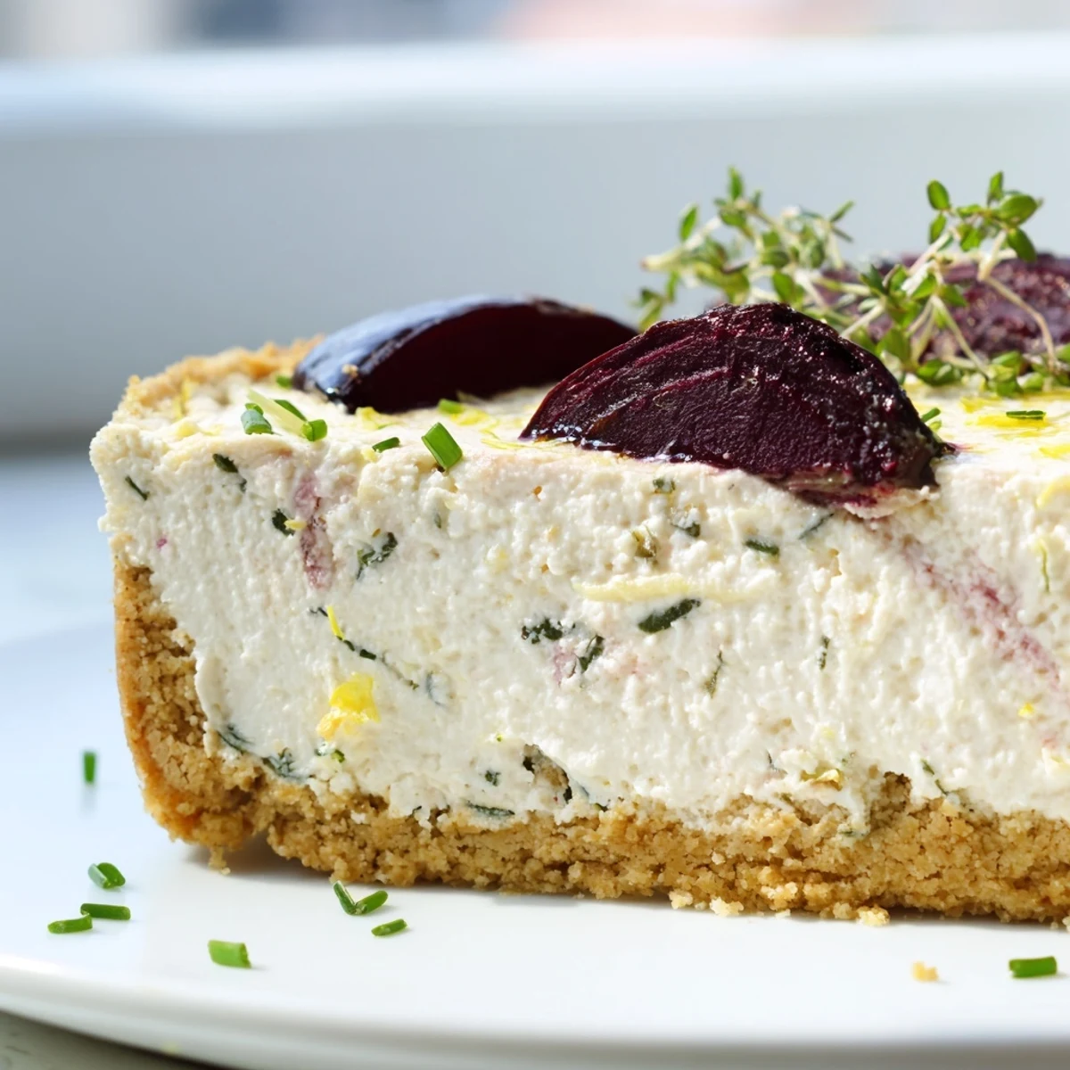 Creamy savoury cheesecake topped with caramelized roasted beetroot and fresh herbs