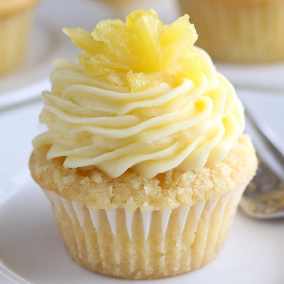 Dole Whip Cupcakes Recipe: fluffy pineapple cupcakes swirled with creamy yellow frosting