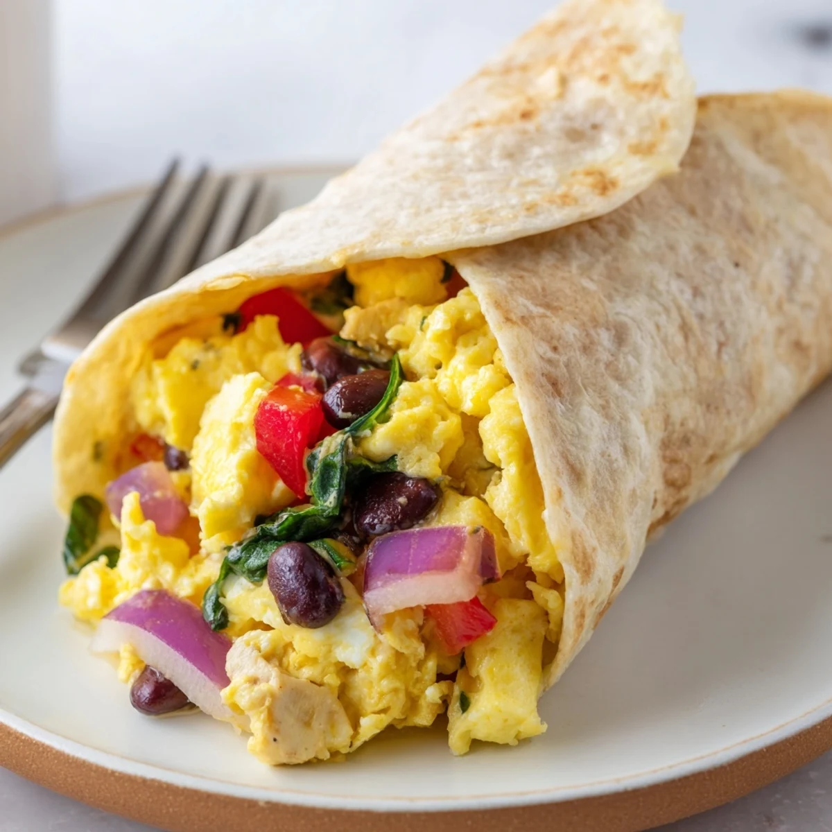 Protein Breakfast Burrito with melty cheddar, turkey, spinach, and warm whole-wheat tortilla