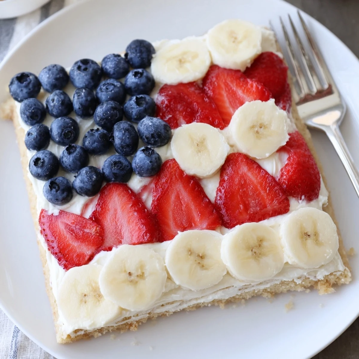 American Flag Fruit Pizza with glossy berries and creamy frosting, chilled for serving