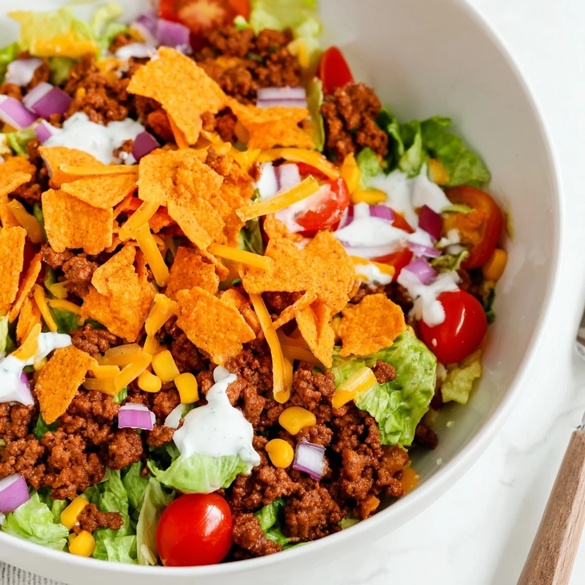 Colorful bowl of Simple Doritos Taco Salad with creamy ranch and juicy tomatoes
