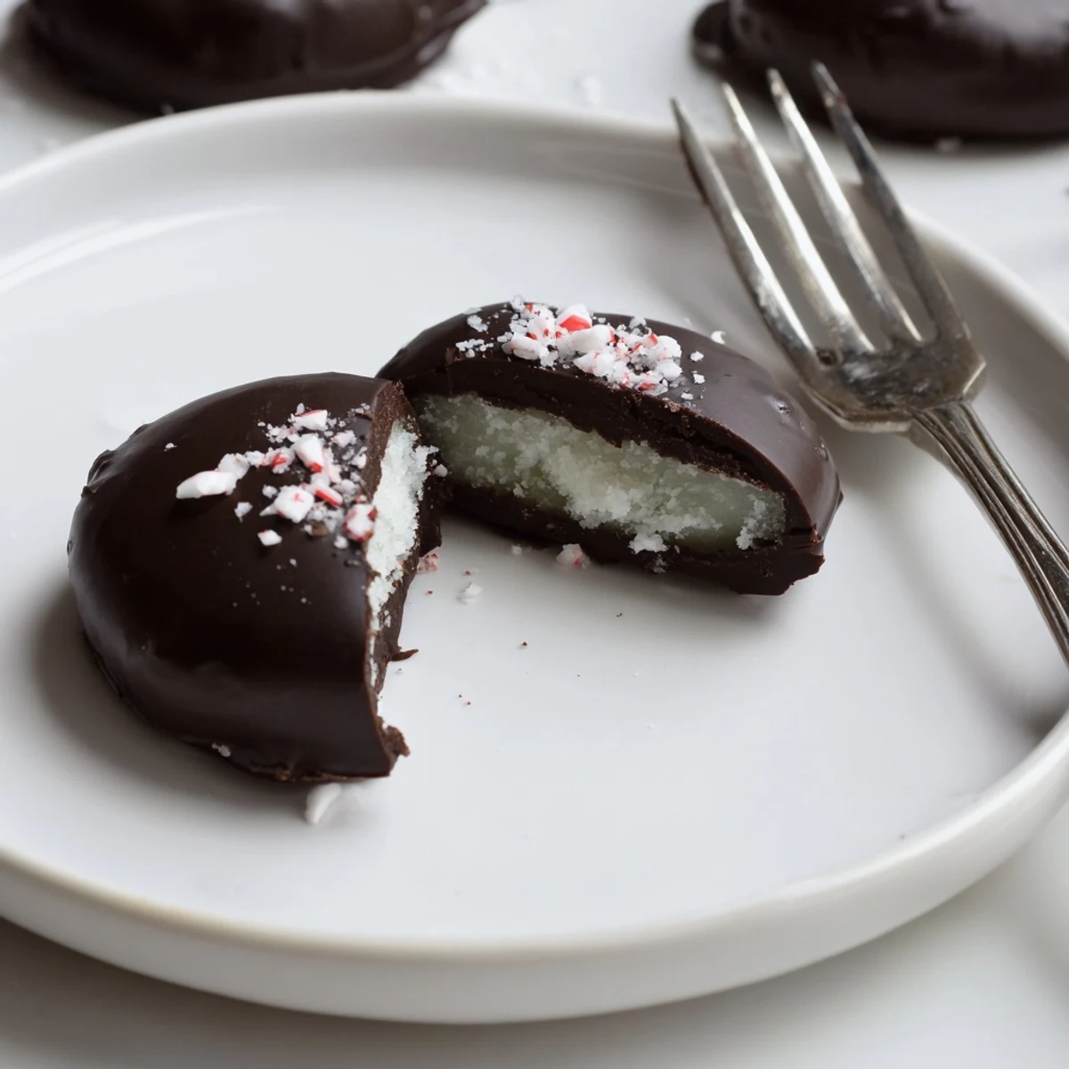 Shiny dark chocolate-coated Peppermint Patties on parchment, cold and ready to gift