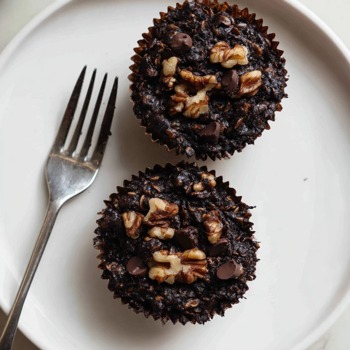 Homemade dark chocolate oatmeal cups with melty chips and chopped walnuts fresh from the oven