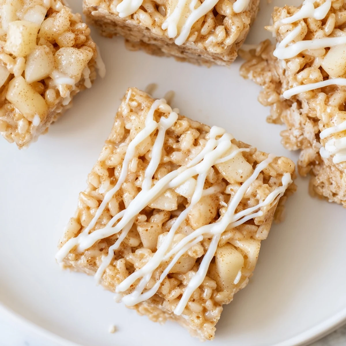 Chewy Apple Pie Rice Krispie Treats squares flecked with warm cinnamon-spiced apples and gooey marshmallow