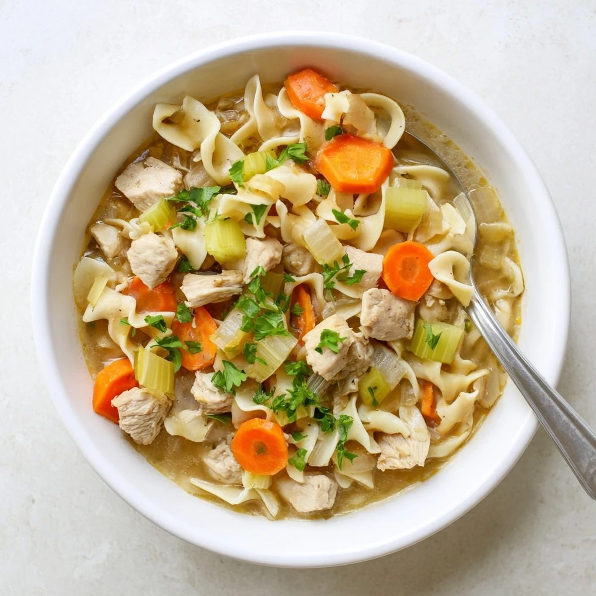 Creamy one pot chicken and noodles simmered with tender vegetables in a savory broth