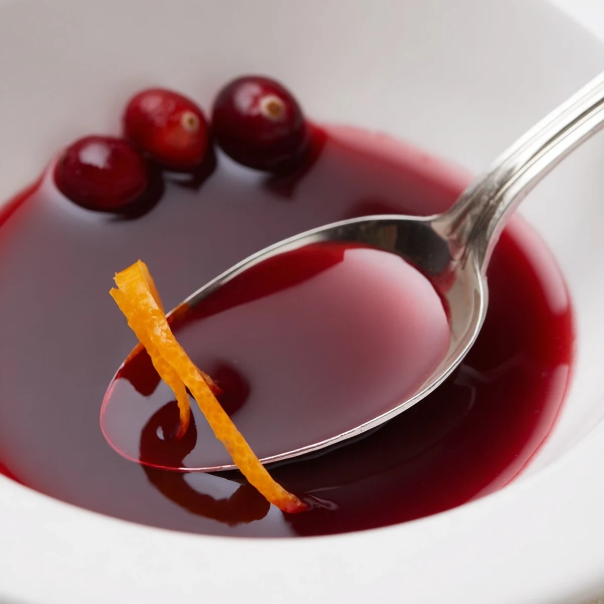 Homemade Cranberry Syrup simmered until glossy, strained, ideal for cocktails.