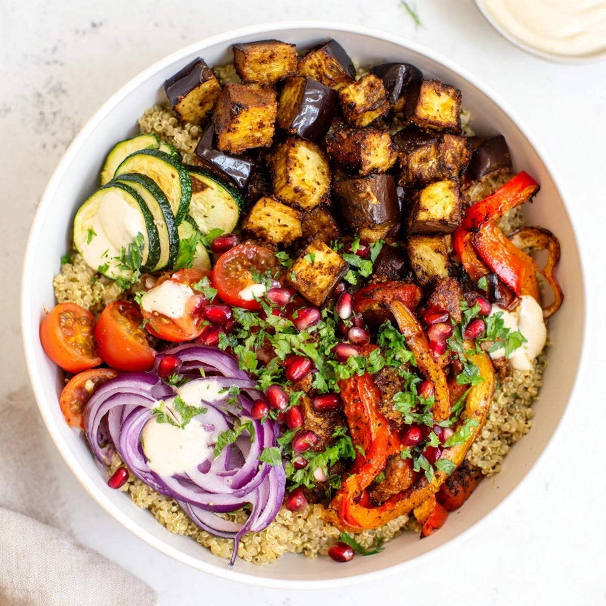 Warm eggplant grain bowl served in a rustic dish with fresh herbs