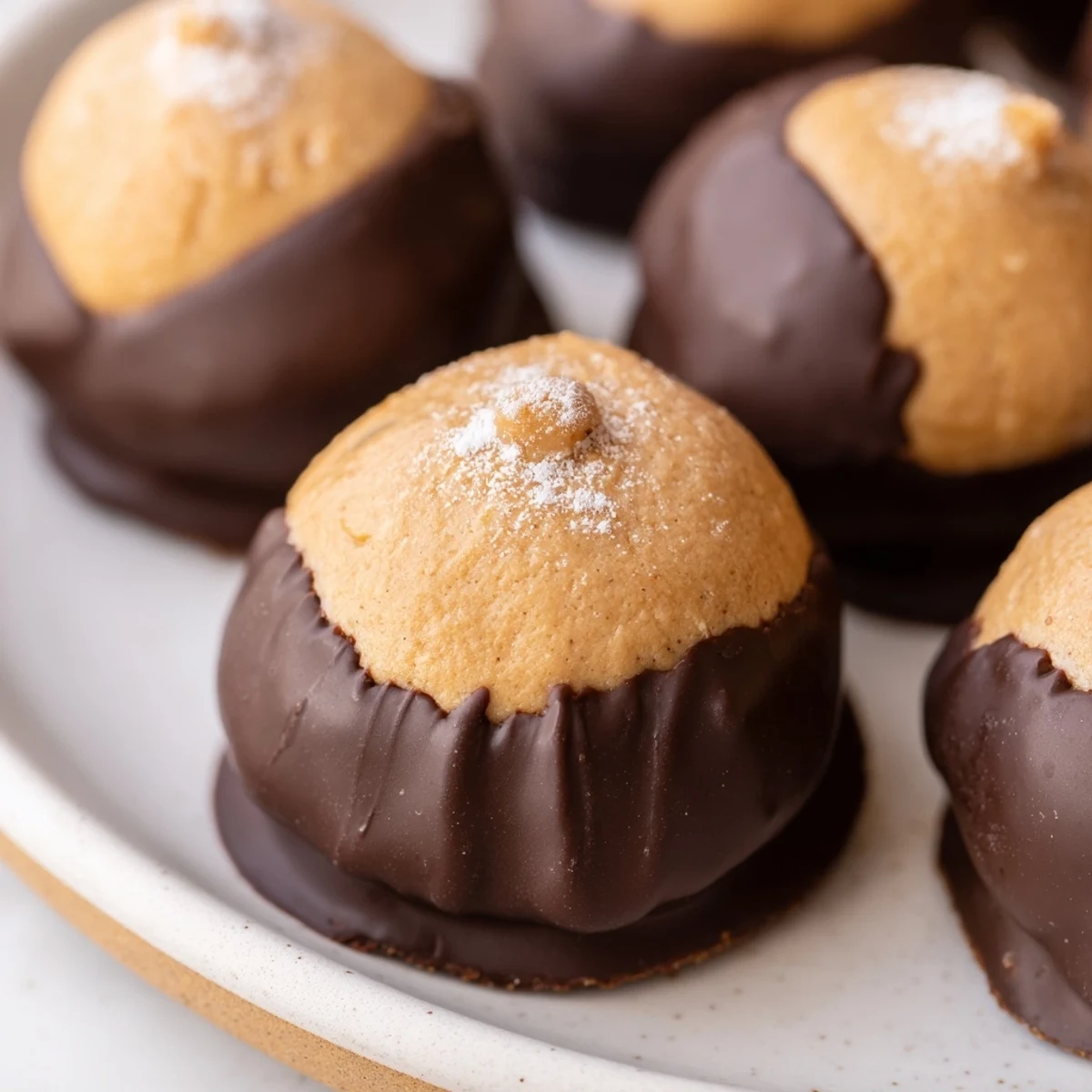 Golden Buckeye Cookies with creamy peanut butter centers dipped in rich semisweet chocolate