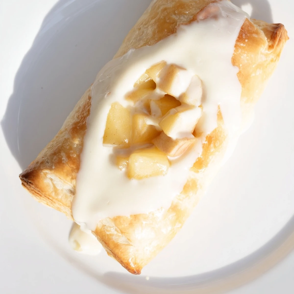 Golden flaky Apple Cheese Danishes baked to perfection on a parchment-lined baking sheet  