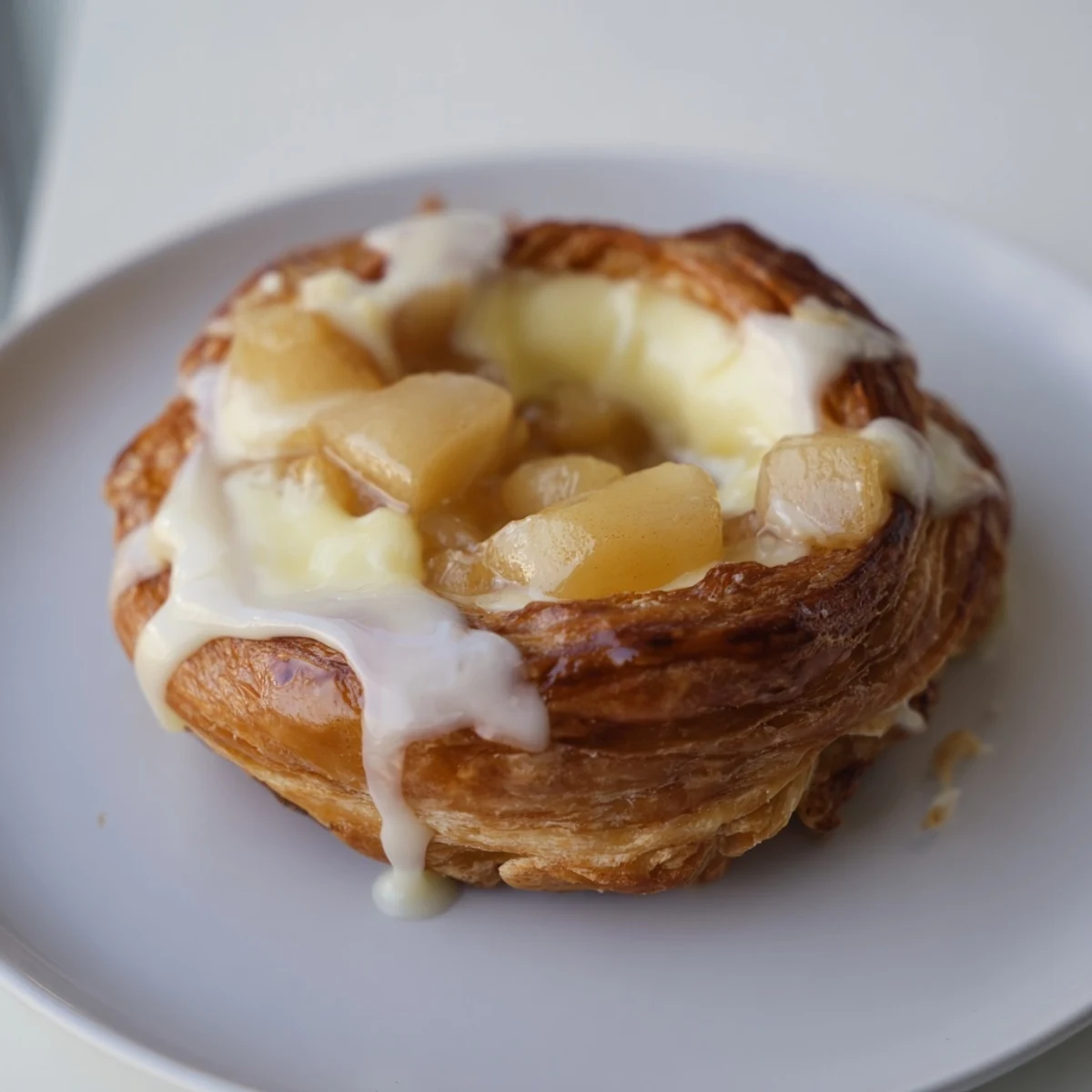 Sweet cinnamon apples and creamy cheese filling nestled inside buttery golden puff pastry squares  