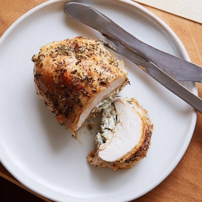 Creamy goat cheese chicken sliced open to reveal a savory herb filling